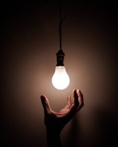 person holding white light bulb